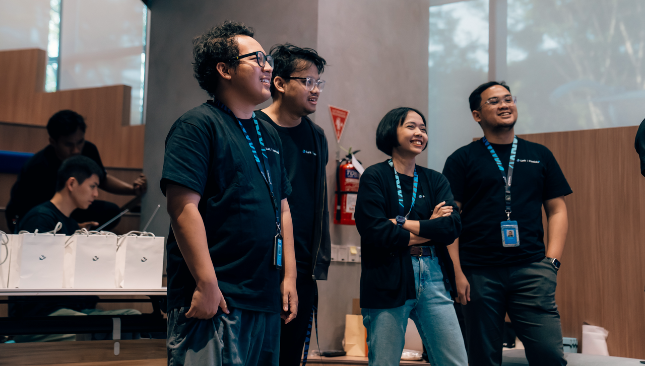 Team members at Lark Traveloka Efficiency Pioneer Competition 2025 smiling during group presentation