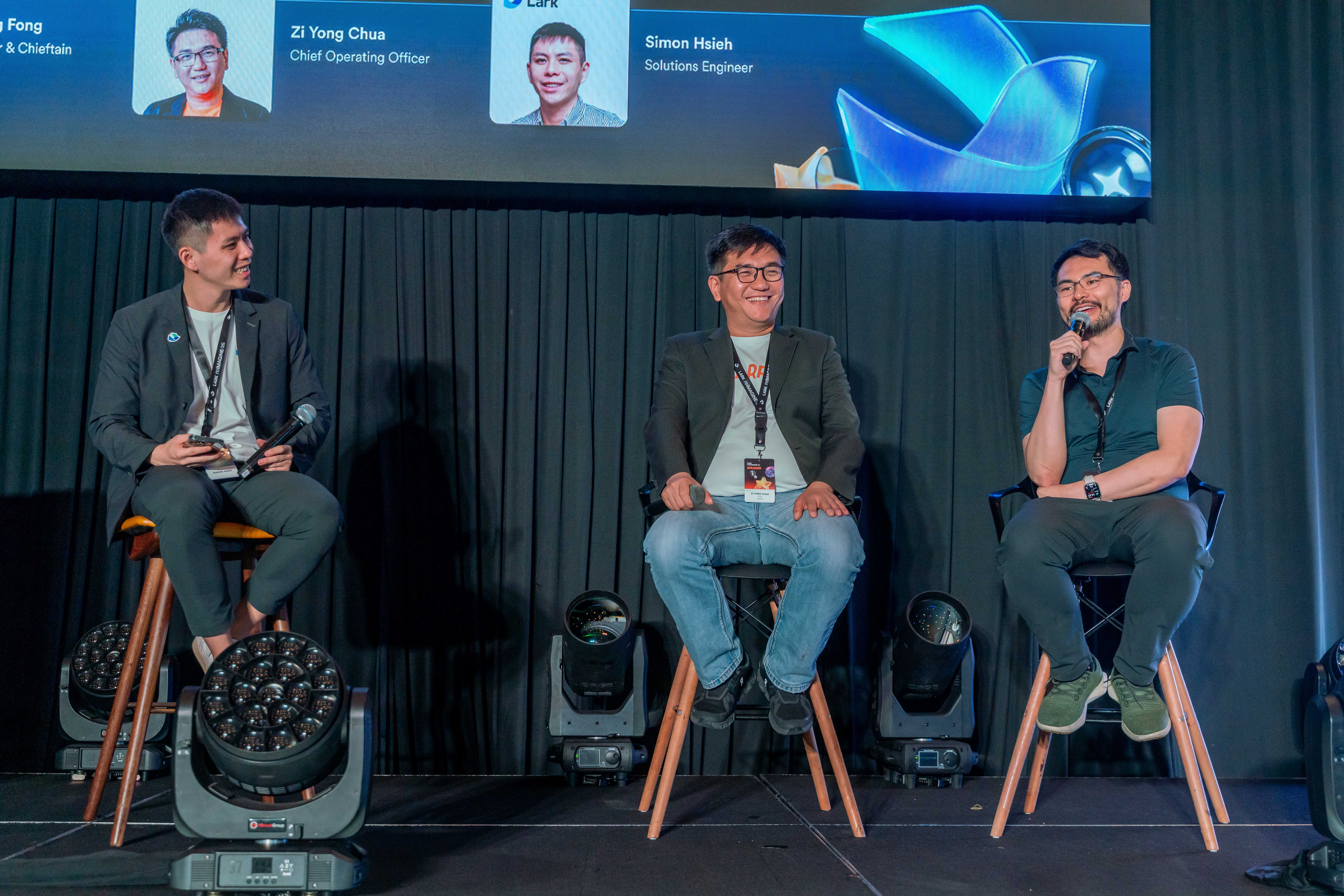 Carro and StoreHub leaders speaking onstage during an AI-first organization panel at Lark Reimagine 2026