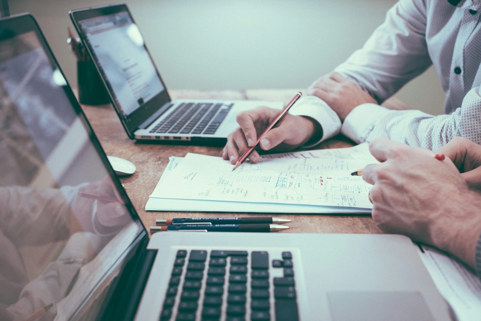 Person taking meeting minutes in front of a desk
