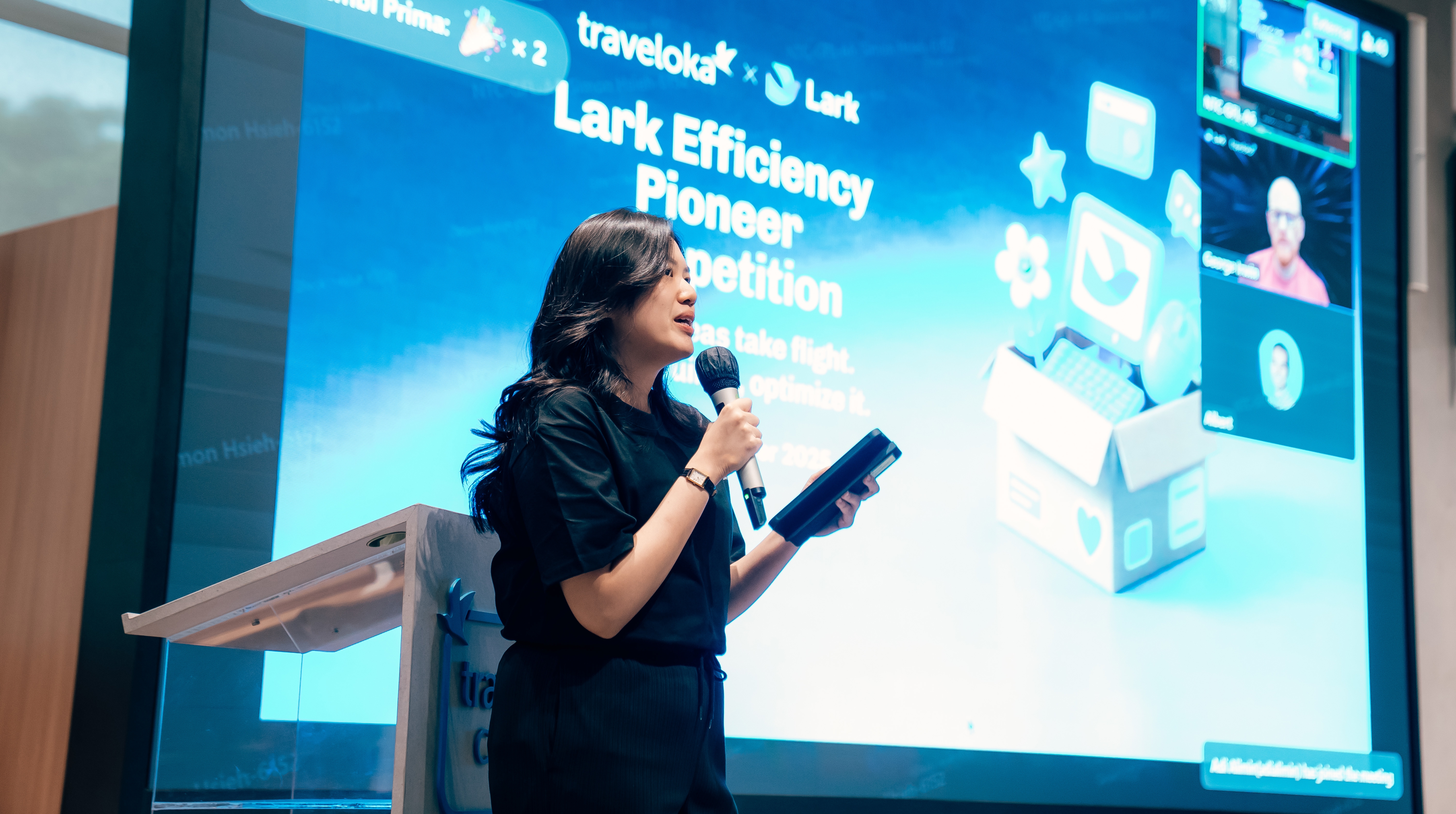 A welcome speech at Lark Traveloka Efficiency Pioneer Competition 2025 on stage